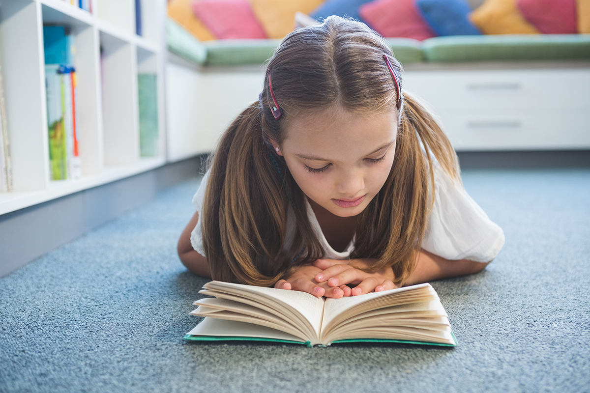 Girl reading on the floor